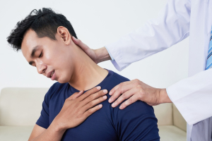 a man getting his neck looked at by a dr 