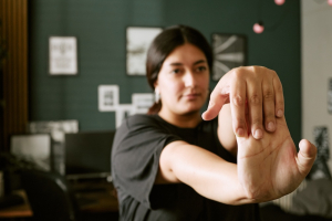 Biracial Woman Doing Hand Stretching Exercises At Home original 4406001