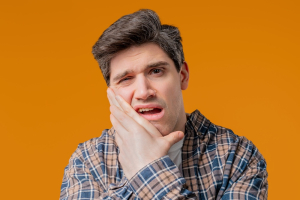 Mature Man Suffering With Toothache On The Yellow Studio original 2865466