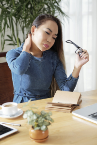 Text Neck Isn't the Problem. Why Your Head Can't Sit Level Is. | Atlas Chiropractic 3 a woman suffering from neck pain